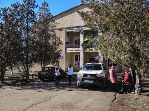 MSF staff members and patients outside the mobile clinic in Pavlopil, Ukraine, 2019. 