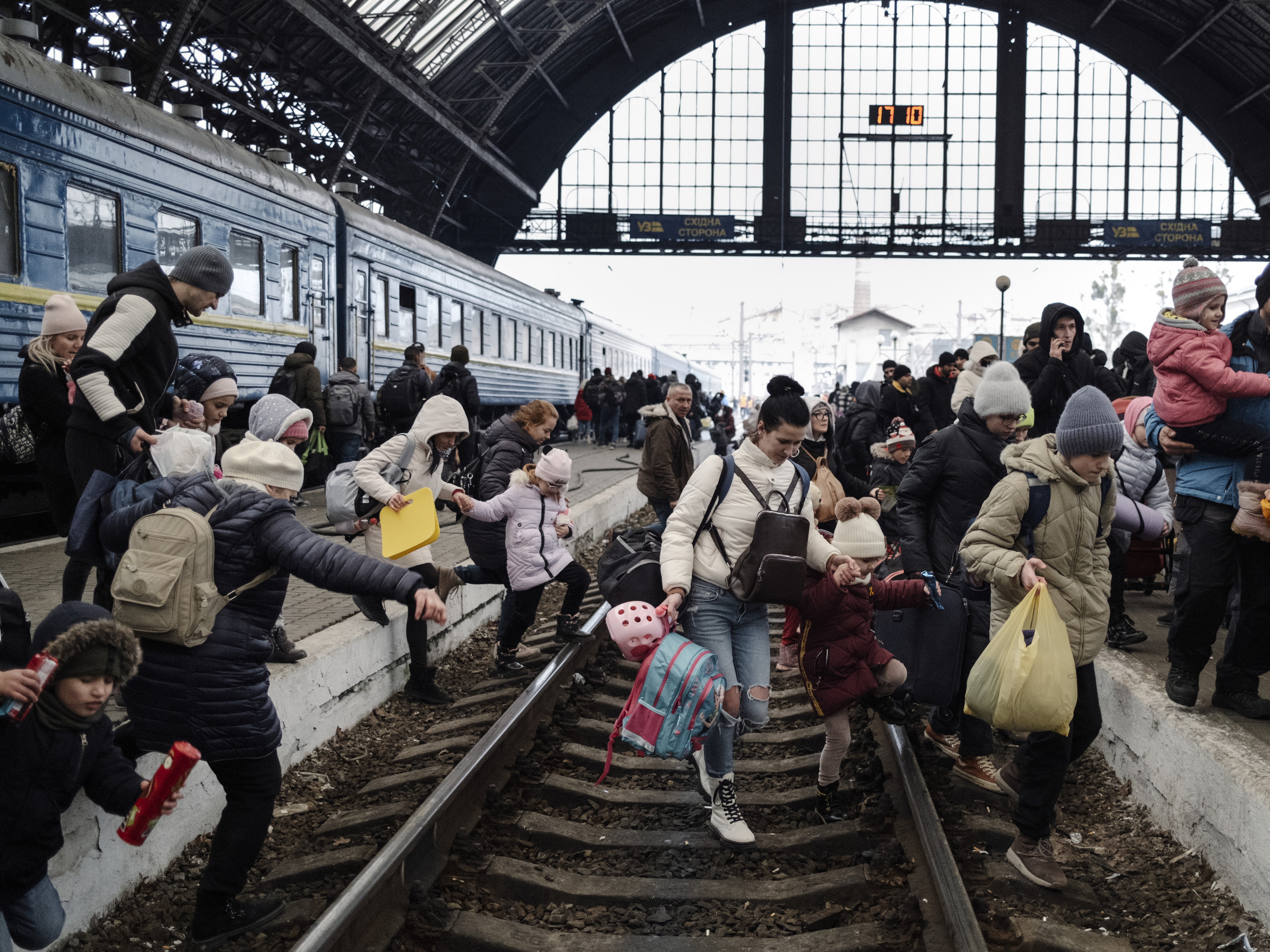 27 February 2022. Hundreds of people trying to escape the on-going conflict in Ukraine wait for a train to Poland at the central train station in Lviv. 