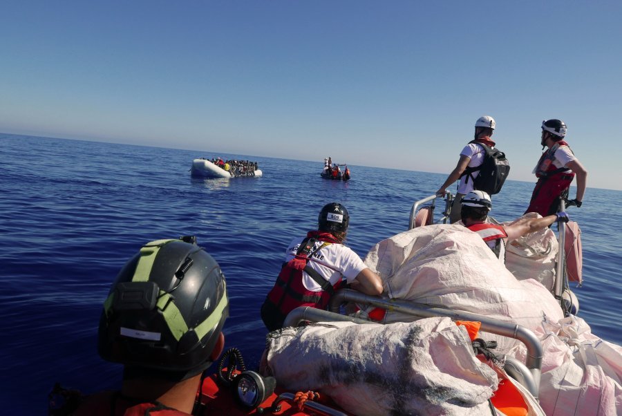 The RHIB with Dr Conor Kenny on board makes its way to the rubber boat in distress. On the other RHIB, cultural mediator Reem Bouarrouj instructs people to remain calm and that we are here to rescue them.