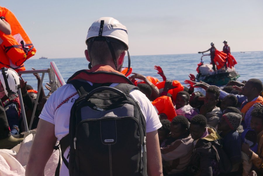 As we make contact with the rubber boat in distress, Dr Conor Kenny conducts a visual assessment as life jackets are distributed.