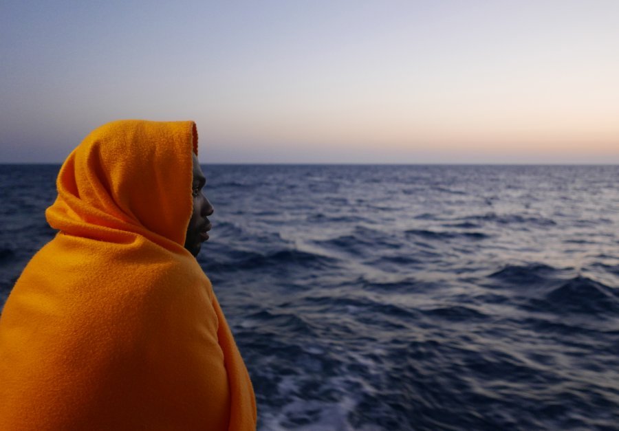 A man looks in the direction of Italy the night before disembarking Aquarius.