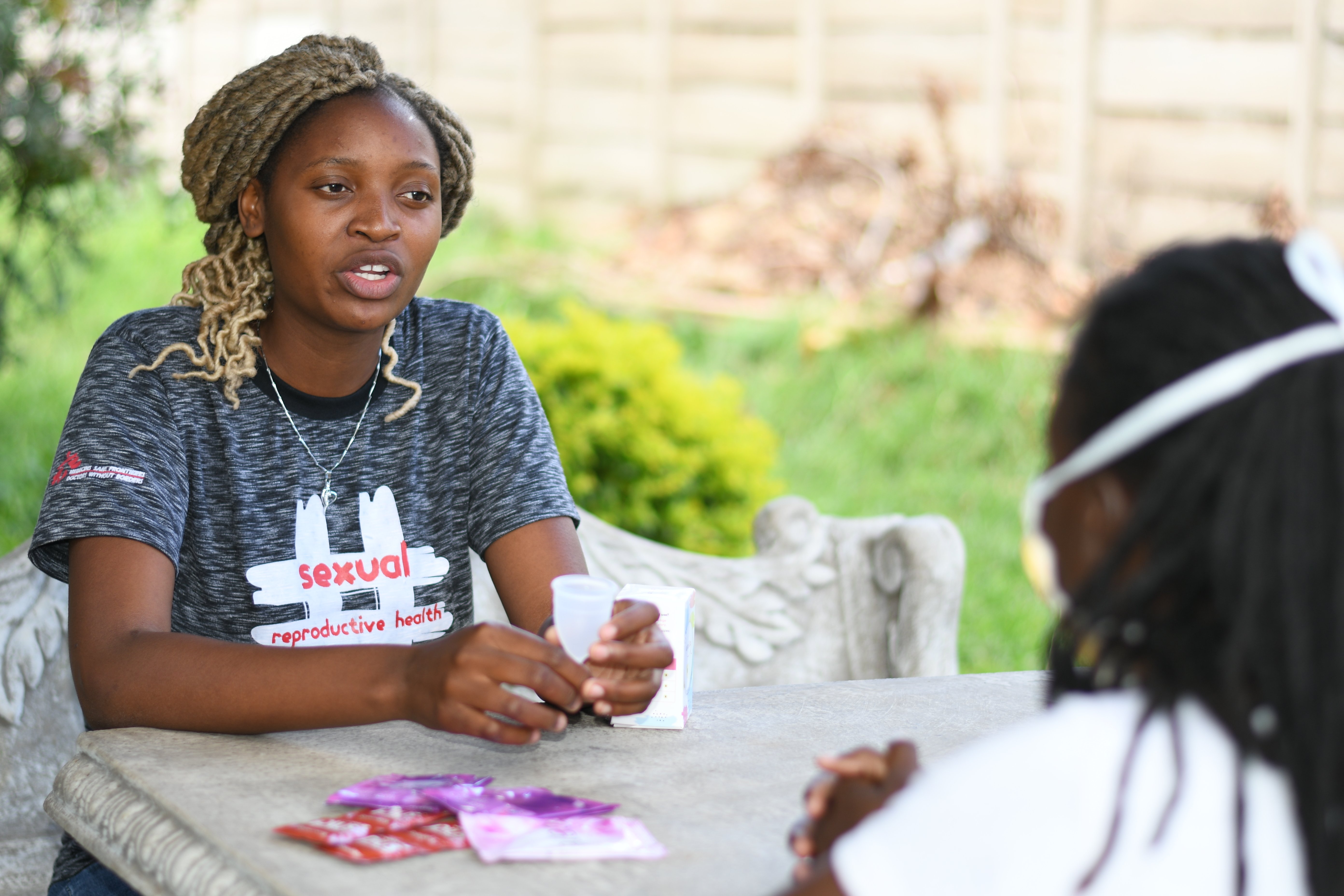 Peer educator having a discussion with young women.