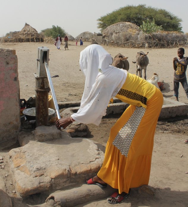 A young girl pumps water in a village near Massakory in Hadjer Lamis province, Chad. (December, 2021).