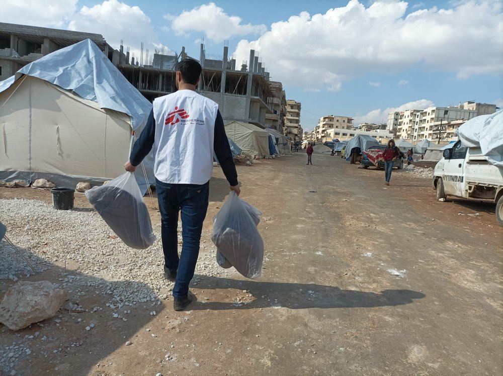 An MSF staff distributing blankets in Afrin, Syria, following the earthquake.