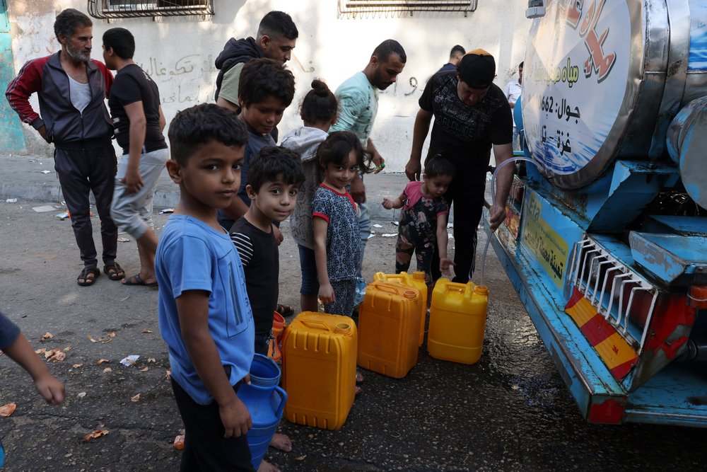 People in Gaza seeking water in tanker trucks after the total shutdown of water and electricity.