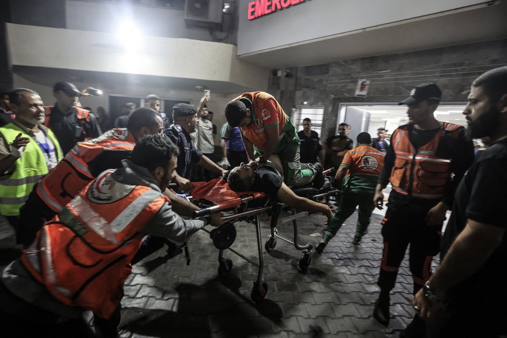 A Palestinian civil defence officer injured in Israeli attacks is given cardiopulmonary resuscitation on a stretcher at Al-Shifa Hospital in Gaza Strip.