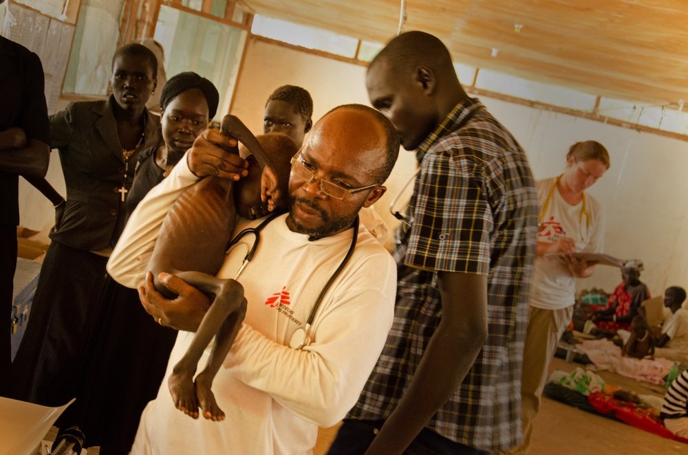 MSF nurtrition nurse Charles Mpona Kalinde attends to severely malnourished two-year-old Gatluok in Leer, South Sudan. MSF nurtrition nurse Charles Mpona Kalinde attends to severely malnourished two-year-old Gatluok in Leer, South Sudan.