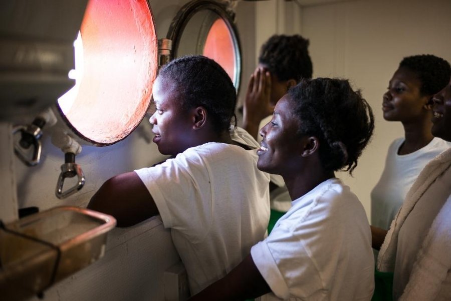 Women on board the Aquarius look out towards the Mediterranean Sea.