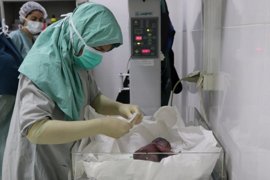 A nurse talking care of a newborn baby in the operating theatre of Boost Hospital.