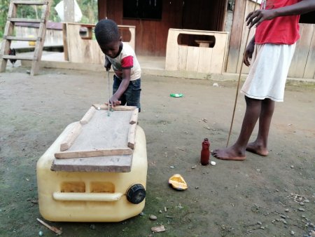 Children play with a makeshift billiard table in a village in the Pacific region of Nariño, Colombia.