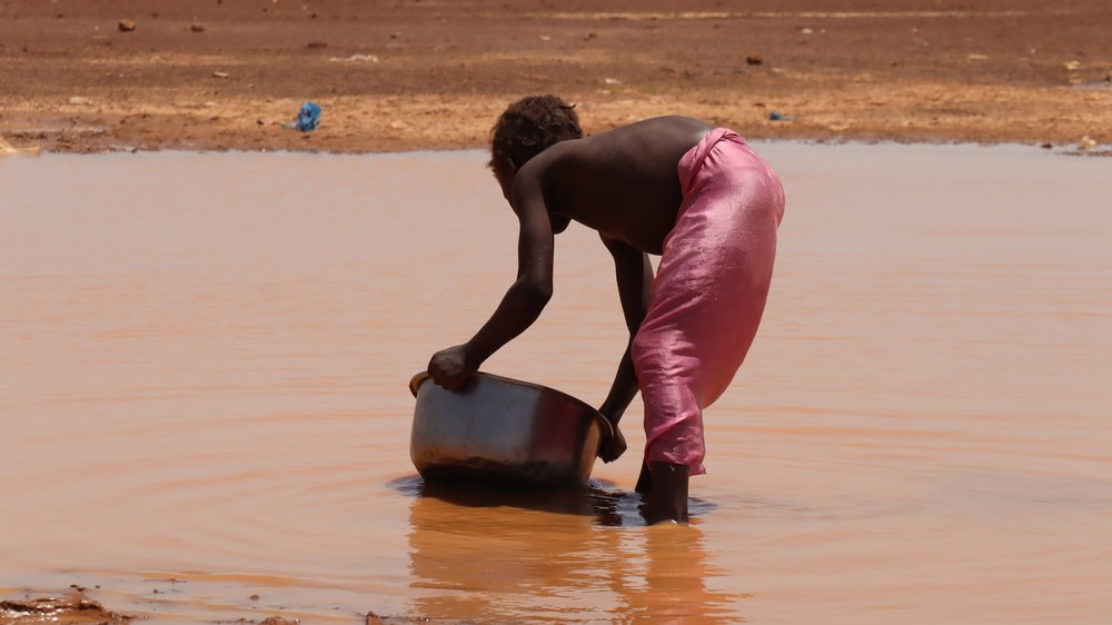 Although they carry all sorts of waste from open defecation and weather-destroyed latrines, rainwater is valuable for bathing and household activities for most  IDPs, as it is here on the way to the ex-Camp Peul and the IDP site in Sector 1 of Barsalogho.