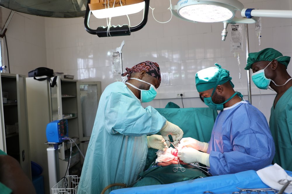 In the operating theatre of Popokabaka General Referral Hospital, MSF surgeon Johnny Kasangati and his team perform surgery on a patient with a perforated bowel due to typhoid fever.