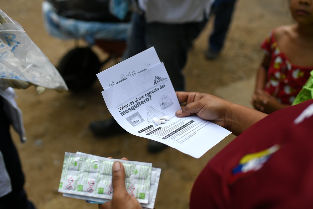 MSF health promotion teams distribute information about how to make water safe to drink and the correct use of mosquito nets to prevent malaria. 