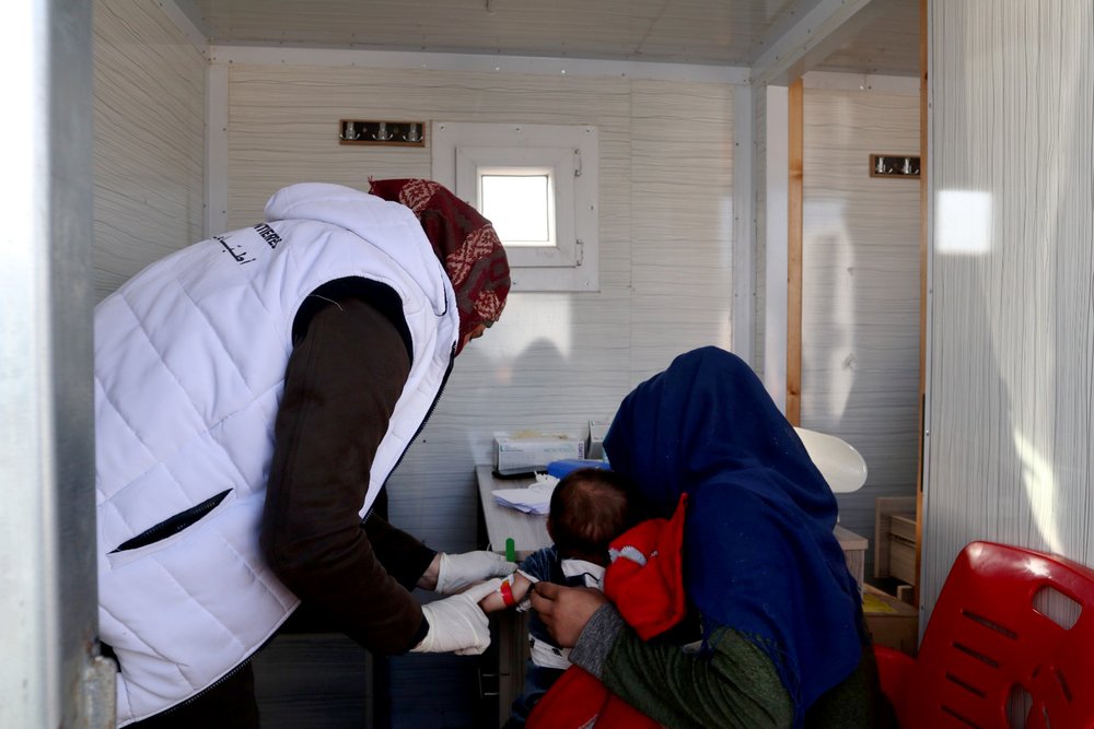 On February 17, 2020, a displaced Syrian woman is getting her son screened for malnutrition at the MSF mobile clinic in Qadimoon camp (Northwest Syria).