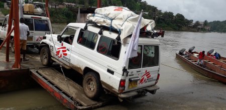MSF cars boarding a ferry to cross the Telembi River in Nariño. The region of vast jungles and rivers requires a large logistical effort to get medical teams to remote villages.