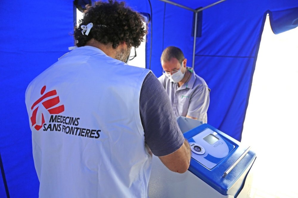 Alfredo, MSF Logistics Coordinator, and Guillaume, Biomedical referent, checking the equipment for the newly opened COVID-19 treatment facility set up in Huacho, Peru.