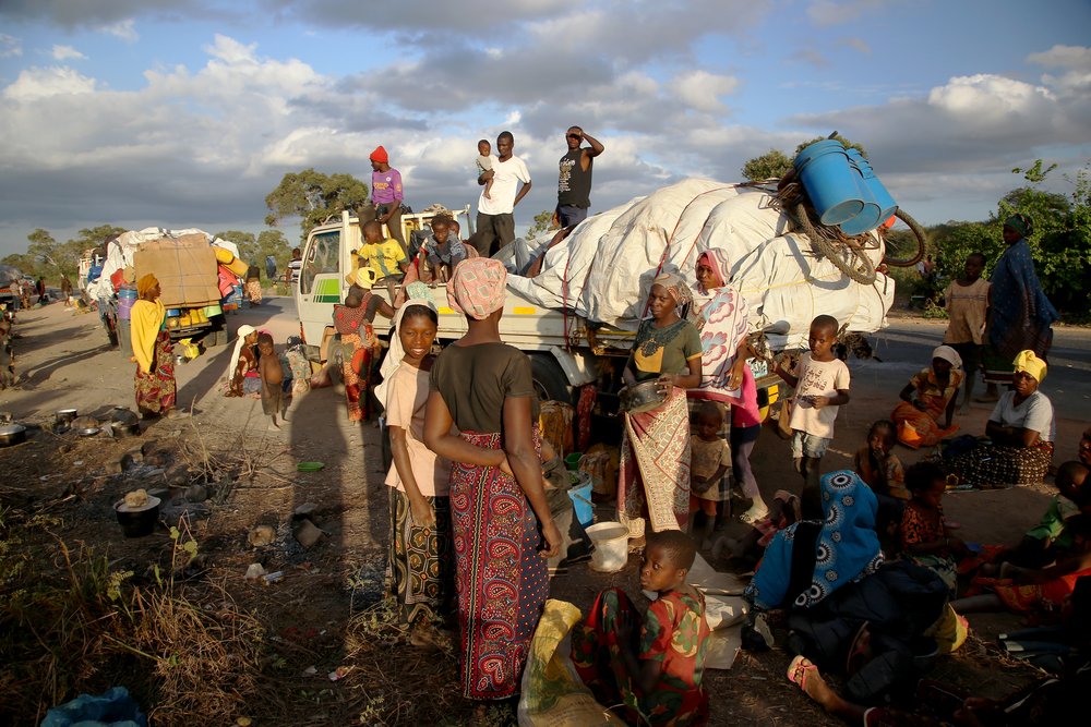People displaced by the conflict in Cabo Delgado, a northern province in Mozambique, wait next to a truck on the outskirts of Mueda. (December, 2021).