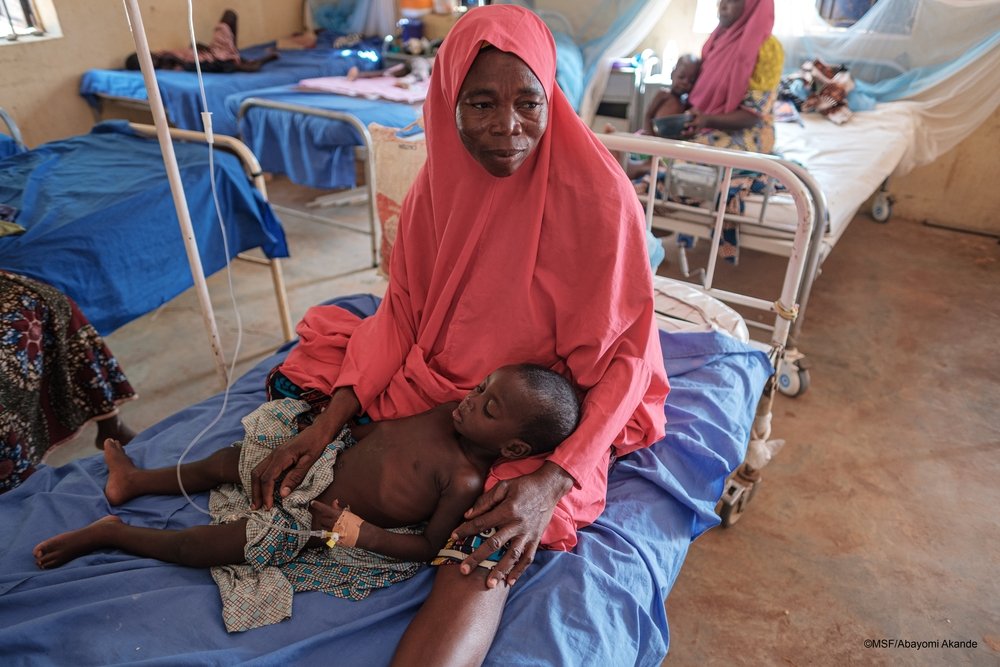 Salamatu A. with her 2 year-old so, who has malaria, in the paediatric ward of Shinkafi hospital, Zamfara state, northwest Nigeria.