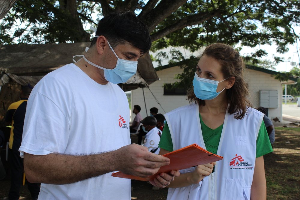 A training in safe use of PPE is held in Port Moresby for newly hired staff members. The project coordinator, Shah Khalid, instructs the nurse, Pauline Louaisil.
