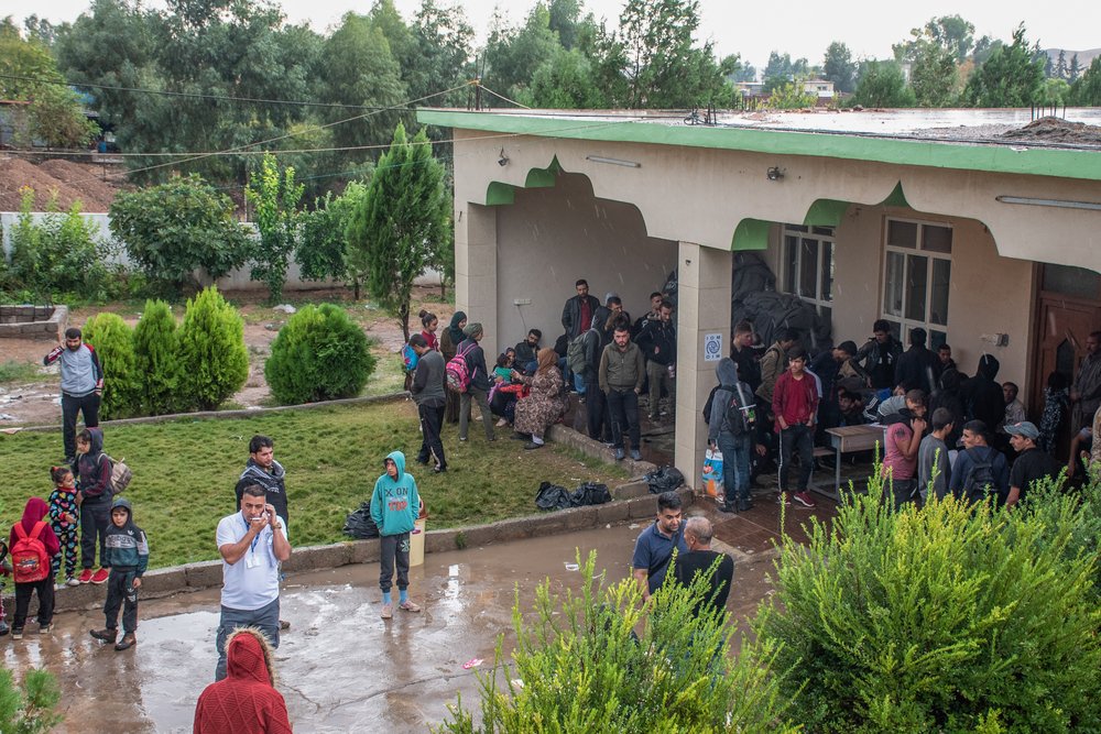 Newly arrived refugees from NE Syria in a mosque in Khale village, that is used as one of the registering sites for the new arrivals, waiting for their names to be called for the busses to be taken to Bardarash camp.