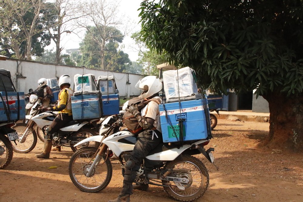 Cold chain equipment – needed to keep measles vaccines refrigerated – is loaded on motorcycles. MSF emergency team is ready for a journey of nearly 180 kilometers to Bosobolo, North Ubangi, where MSF is responding to the increase in measles cases.