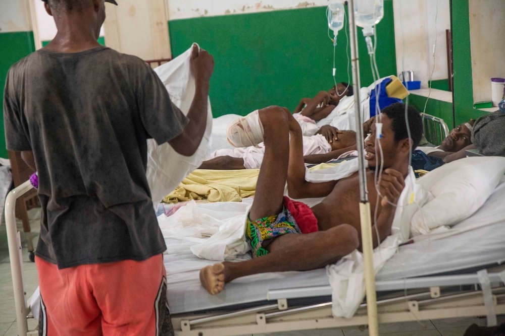 A patient&#039;s father helps him put on his trousers at the general hospital in Les Cayes. MSF is supporting the hospital with supplies.