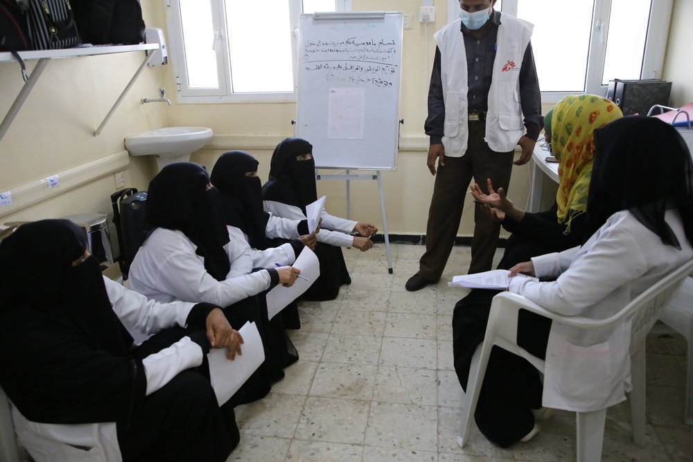 Staff at the Al Qanawis Mother &amp; Child Hospital, in the Hodeidah governorate of northwestern Yemen, meet before the daily rounds.