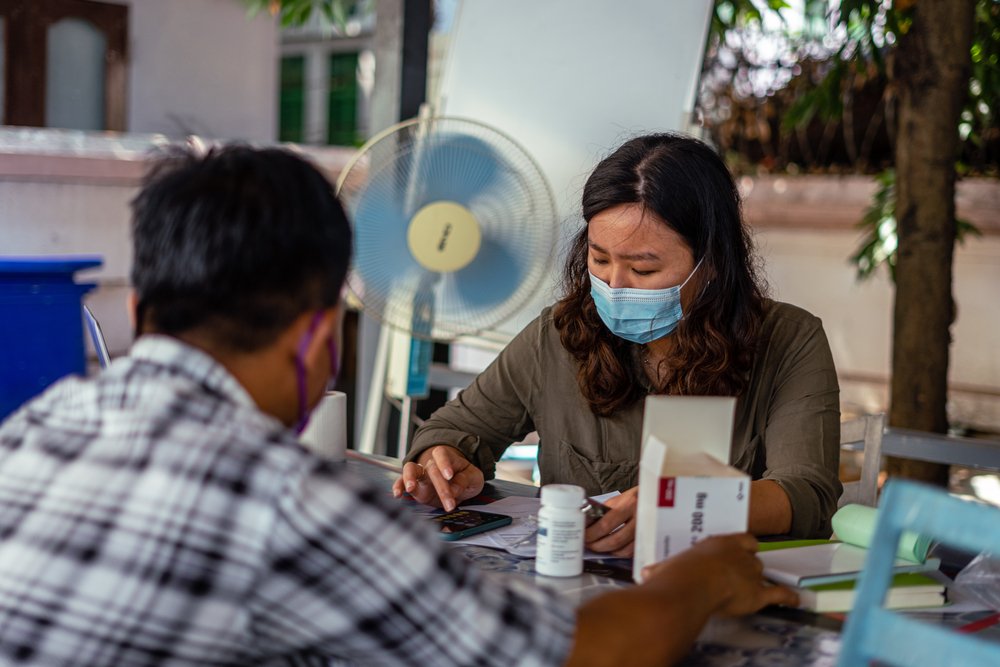 An MSF staff member prepares medication for a patient in Yangon's MSF offices.