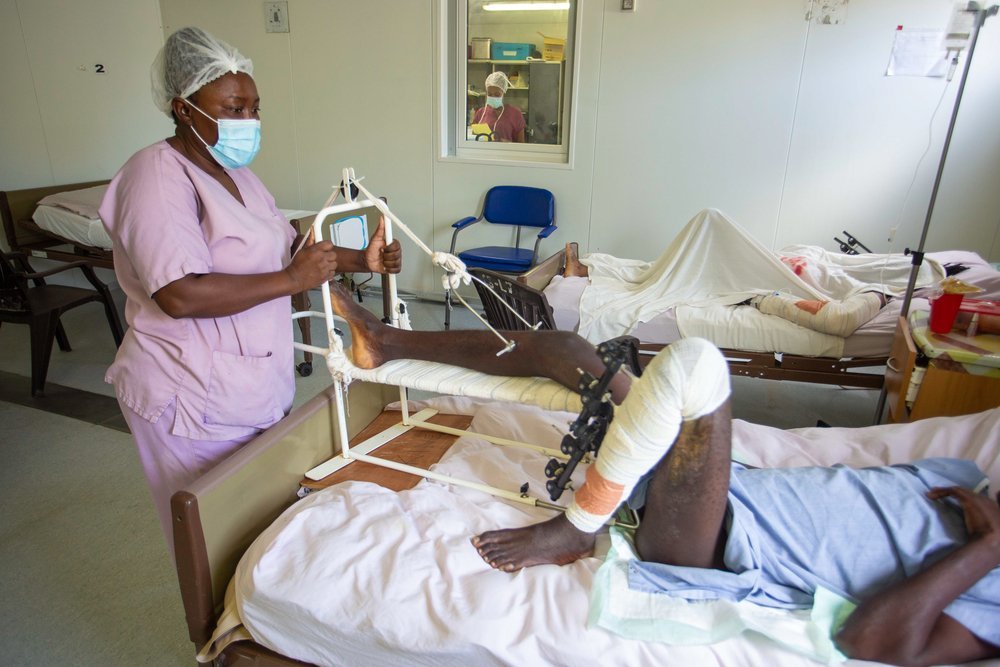 A nurse from Tabarre hospital is treating a patient wounded during the earthquake in the South region of Haiti. He has broken his foot.