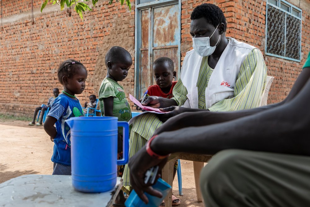 Children of Amoth Wed Duang (Athian, Akoi and Mayen) receive the SMC medication from MSF staff, outside of her home nearby the village Kuom, South Sudan, October 26th, 2021.
