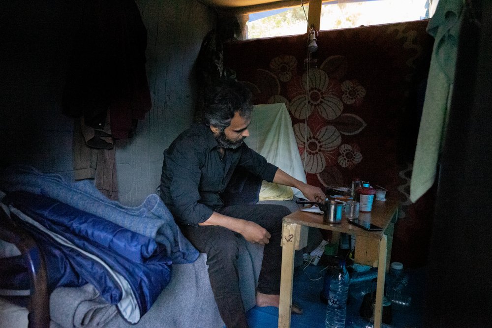Mohamed, 31, inside his tent in Vathy center. Mohamed is from Idlib, Syria.  He left because of the war and looking for safety and a dignified life but until today, he is trapped in an inhuman camp and his suffering seems to have no end. 