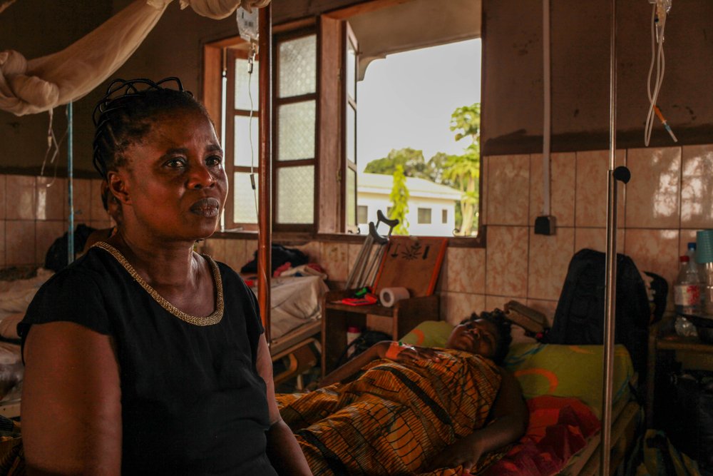 Issa Patricia sits with her daughter Achalle Lucie in Kumba Presbyterian hospital after Achalle Lucie had an operation. After hearing gunfire from every direction, the two of them had been living in the bush to escape the violence.