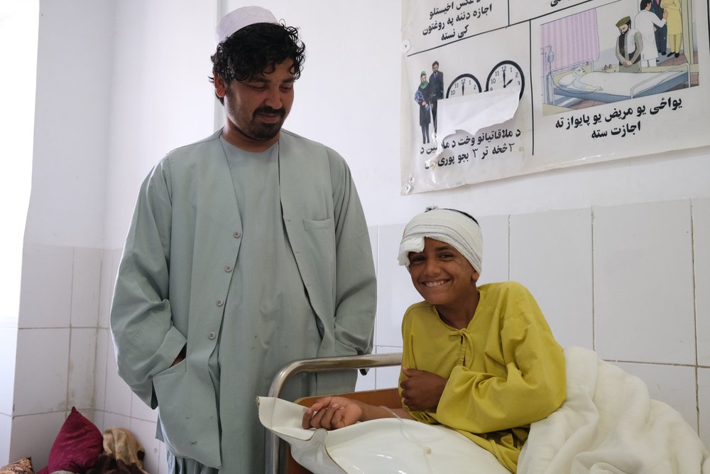 Ahmadullah with his nephew Samiullah, 12 years old, who suffered a gunshot wound to the head on 4 May. Boost hospital, Helmand province, Afghanistan