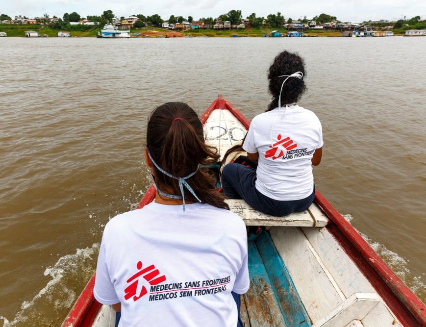 Doctor Ebel Saavedra and health promoter Uliana Esteves cross Lake Tefé by boat for a health promotion activity in Tefé, in the state of Amazonas, Brazil.