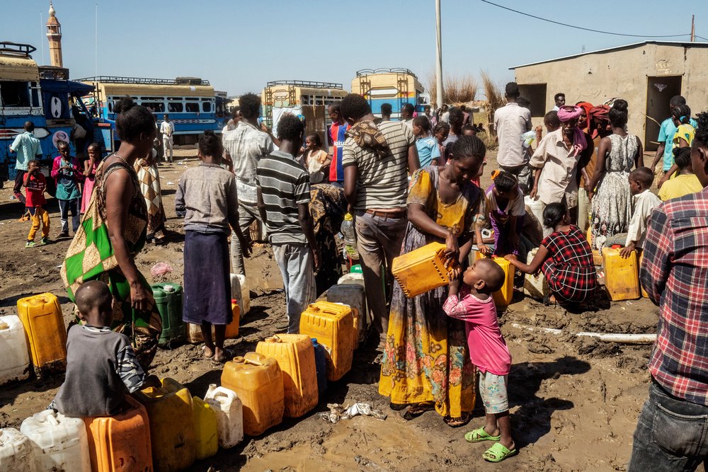 Refugees at a water point in Al Hashaba transit camp.