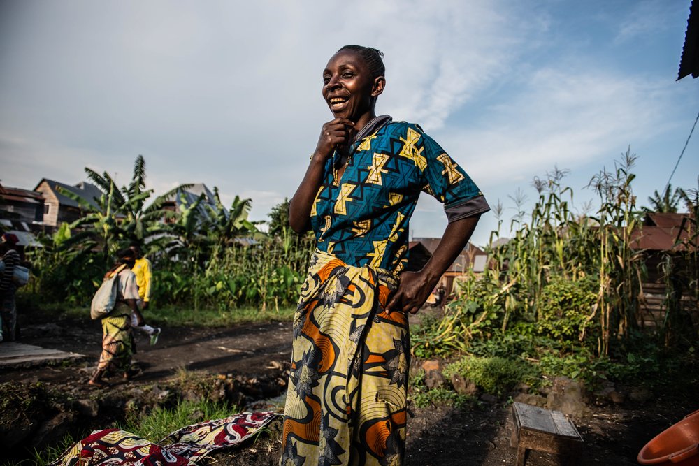 Faida Lumo in front of her house in Sake. The town sheltered about 180,000 people displaced from Goma after the eruption of Mount Nyiragongo. Faida hosted 17 people. 