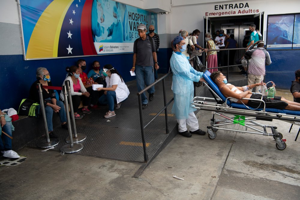 People wait at the entrance to the emergency room at Vargas hospital in Caracas, Venezuela. 