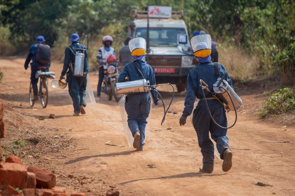 A sprayers’ team who just treated a house against mosquitoes is leaving for the next one on the Ruyaga hill, Kinyinya health district.