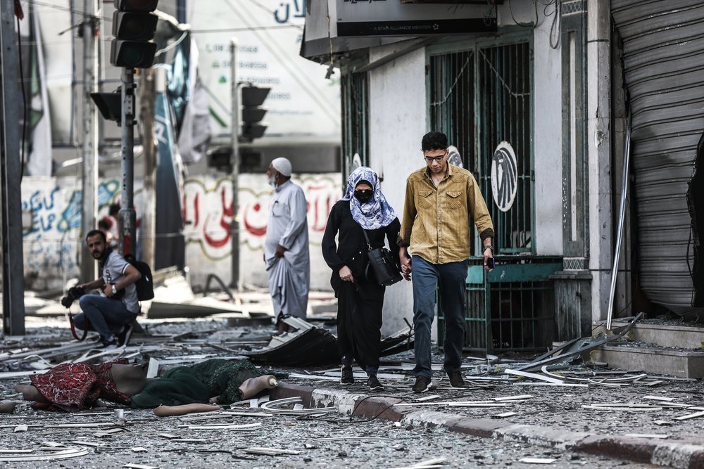 Palestinians walk amidst debris in Gaza city. 11 days of Israel’s intense aerial and ground bombardments has caused a huge impact on people’s lives in Gaza - people lost their family members, their homes and livelihoods. 