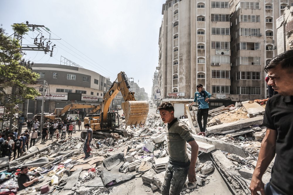 People clear debris after Israeli airstrike destroyed the residential tower in Gaza city. 11 days of Israel’s intense aerial and ground bombardments has caused a huge impact on people’s lives in Gaza. 