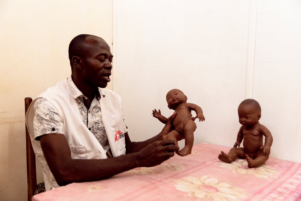 Aimé Césaire Likosso, mental health advisor with the MSF Tongolo project, shows how he uses dolls with child victims of sexual violence, on 30th November 2020. 
