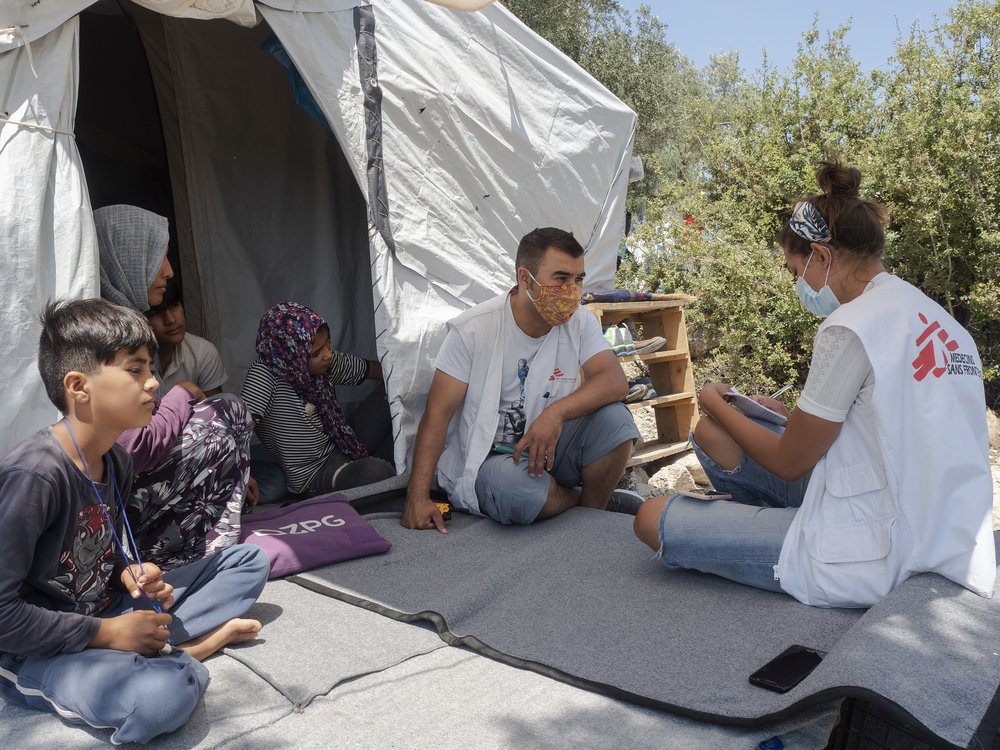 MSF staff speaking with a family from Afghanistan, still separated from two of their children who became lost while trying to reach Greece in 2018