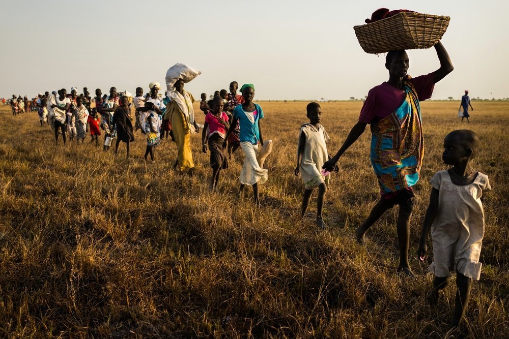 Tens of thousands of people from all over the nearby region prepare to receive their first distribution in many months in Thonyor, South Sudan. Many residents from Leer fled to Thonyor feeling saver there. 