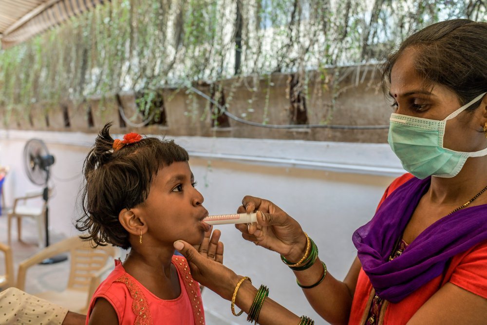 Mother of six-year-old MDR TB girl child administering manipulated form of DRTB drugs.