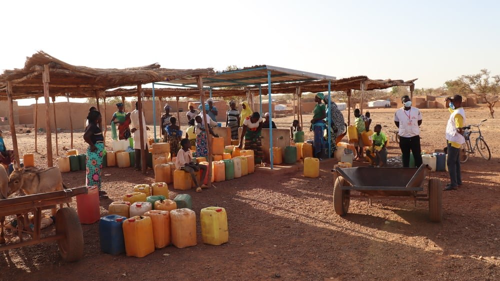 Women and children filling their jerry cans with clean water at a newly rehabilitated borehole in the town in Titao in Burkina Faso’s North region. The lack of clean water can cause different parasitic infections and other water-borne diseases.