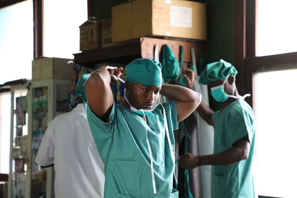 MSF doctor José Mbuta dresses up before entering the operating theatre of Popokabaka General Referral Hospital. 