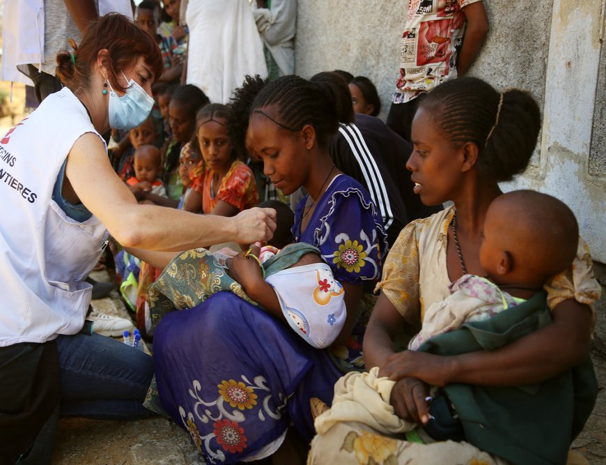 MSF nurse checks the middle-upper arm circumference of a child brought for a medical consultation by her mother to a mobile clinic in the village of Adiftaw, in the northern Ethiopian region of Tigray. (March, 2021).
