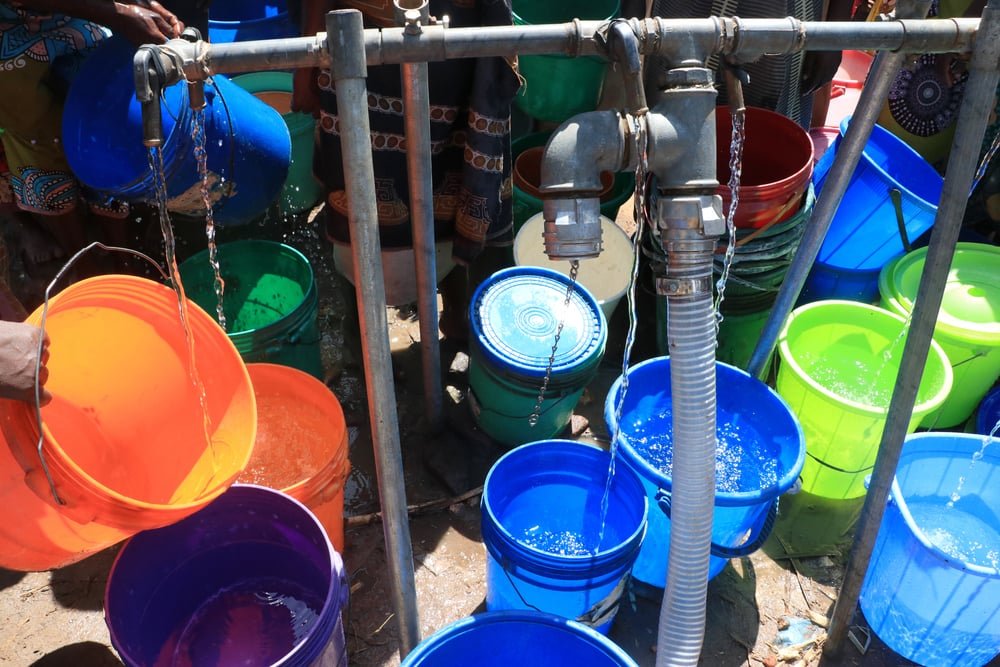 Dozens of buckets are seen at a water pumping station at Bangula camp for displaced people. (February, 2022).