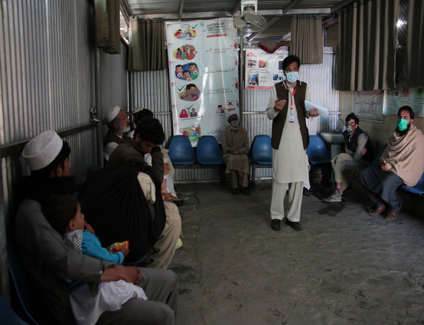 Health promoter Sarir Ahmad is holding an awareness-raising session on COVID-19. Since the first report of a COVID-19 confirmed case in Pakistan, our health promotion team has incorporated COVID awareness messages into their sessions on health and hygiene