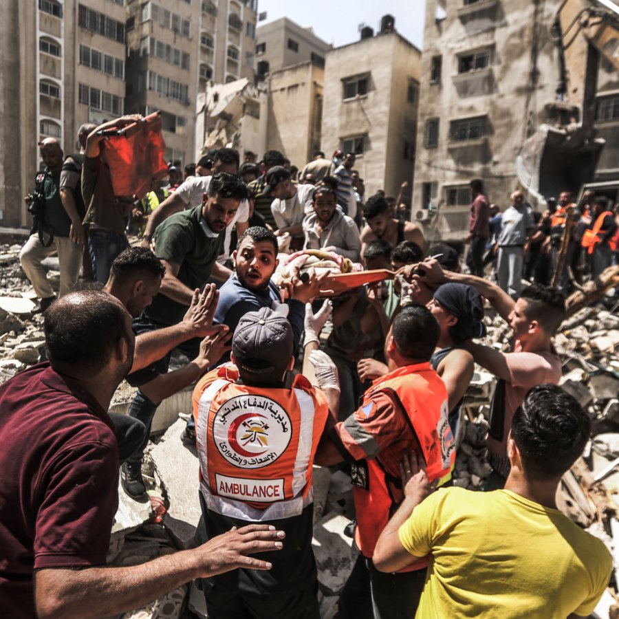Palestinians rescue a person from the rubble after Israeli air strike destroyed the residential tower in Gaza city.